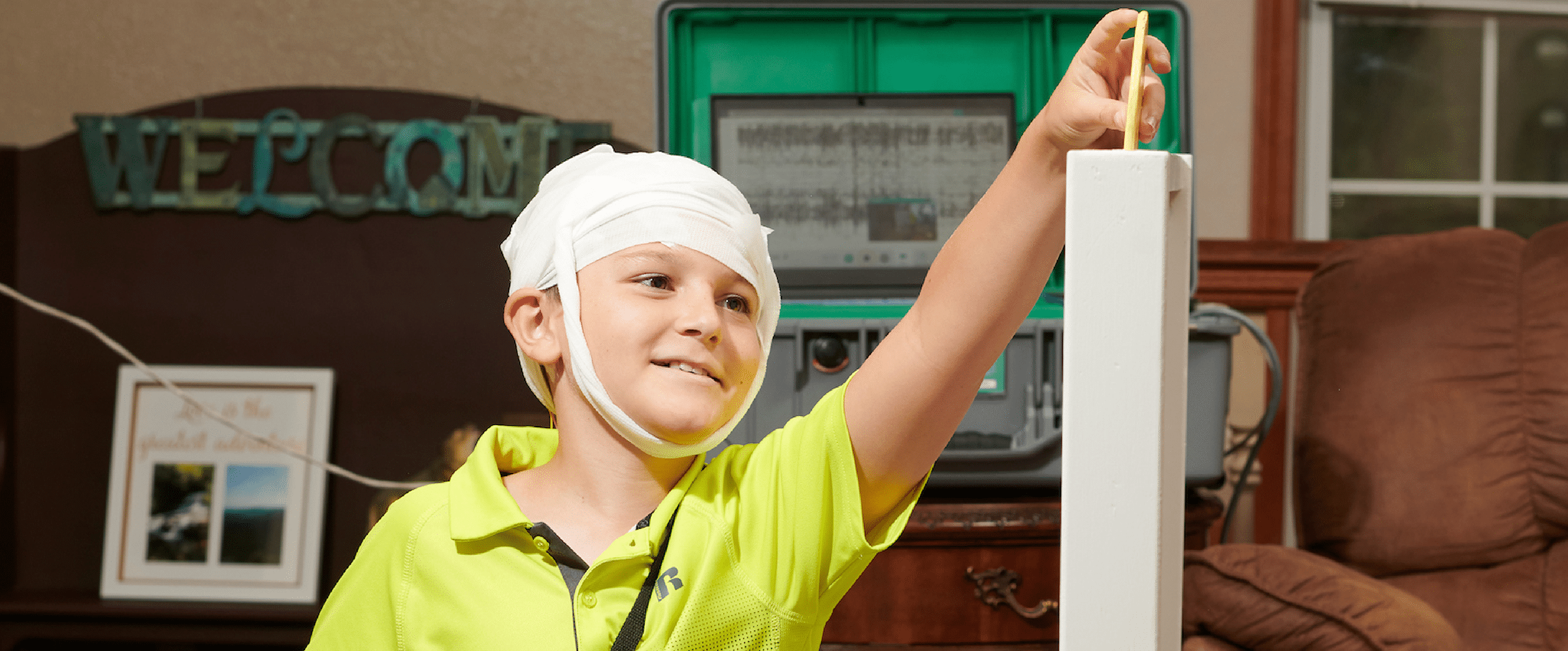 young boy wearing an EEG head wrap